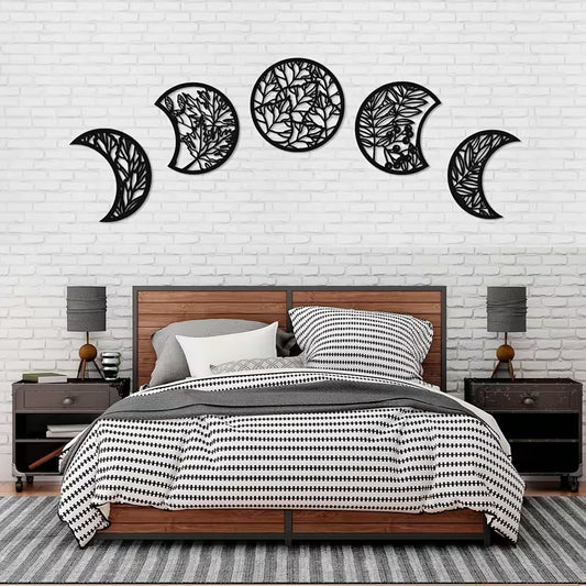 Bedroom with decorative wall art resembling moon phases on a white brick wall.